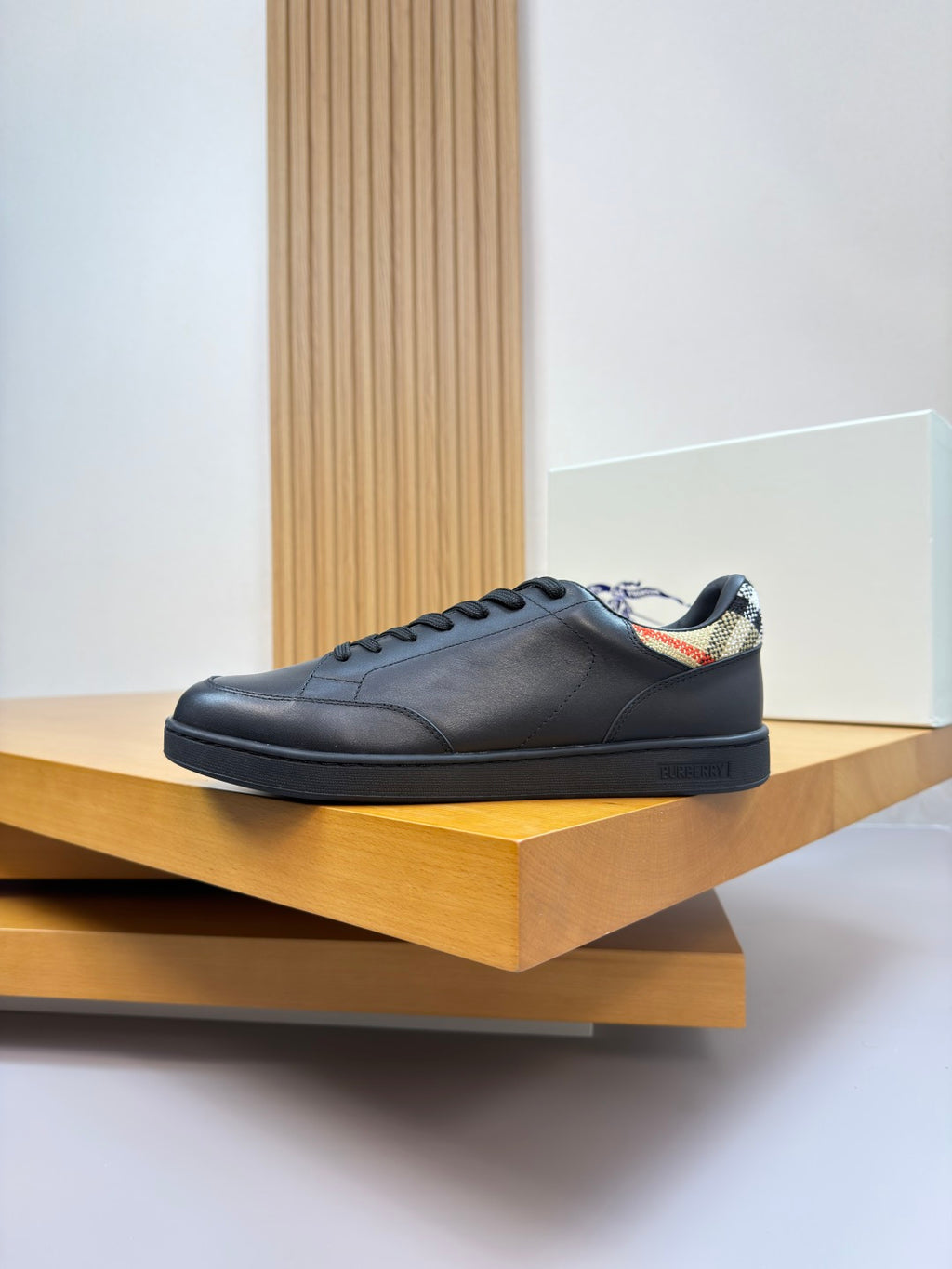 Burberry black leather lace-up sneakers on display shelf