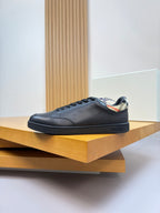 Burberry black leather lace-up sneakers on display shelf