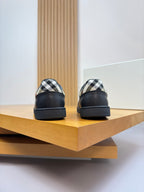 Burberry black leather sneakers with check-print heel panels and logo detail