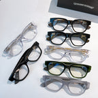 Assorted eyeglasses with clear, black, green, and gray frames on display