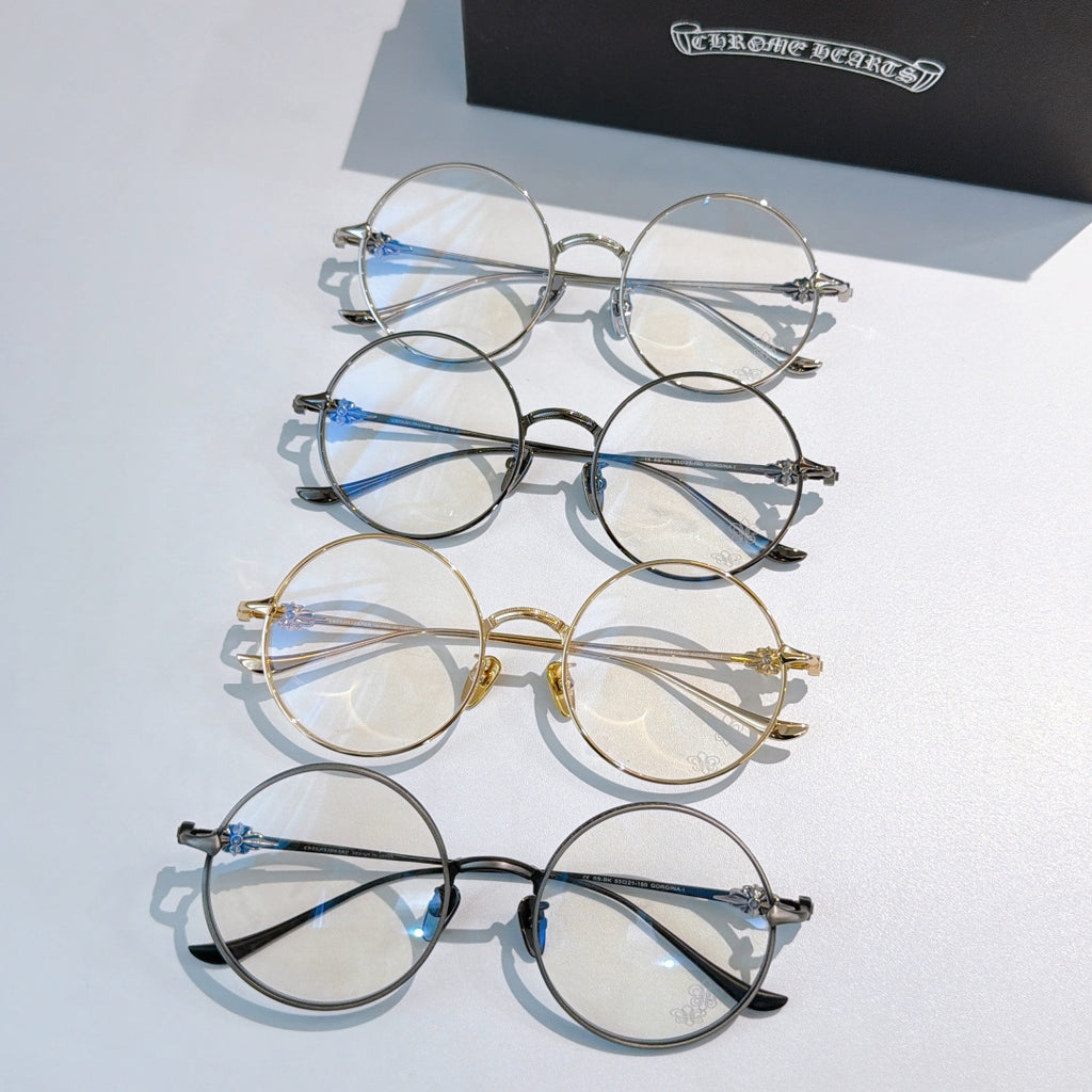 Assorted round eyeglasses with silver, gold, black, and blue accents arranged in a set.