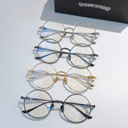 Assorted round eyeglasses with silver, gold, black, and blue accents arranged in a set.