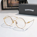 Gold-toned round eyeglasses with thin metal frame and small blue logo on bridge.