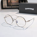 Silver round eyeglasses with blue temple emblem and clear lenses, thin metal frame.