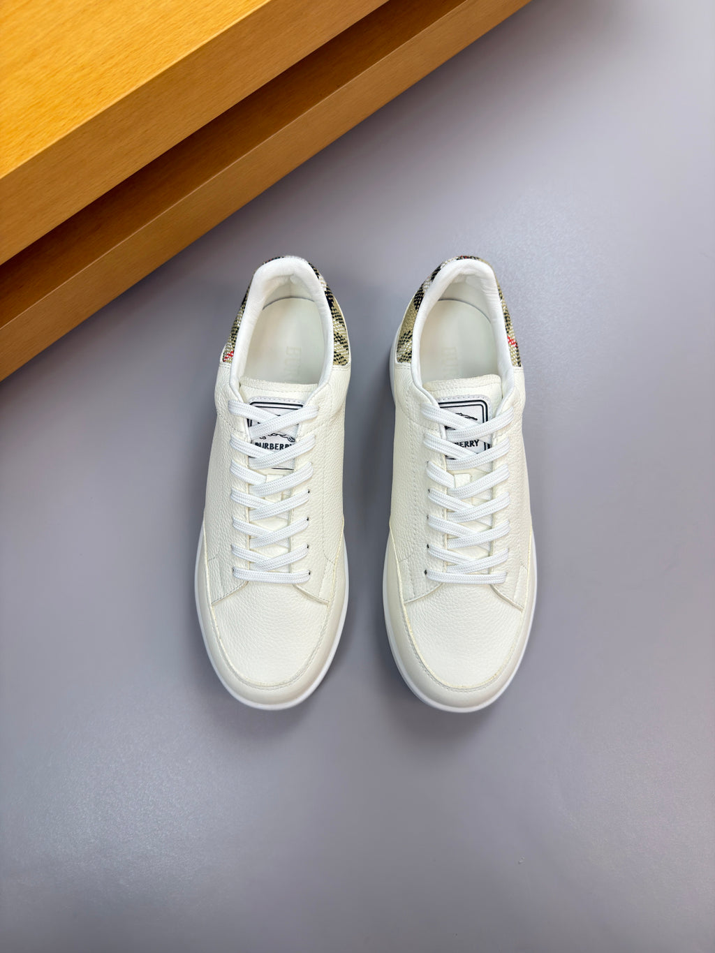 Pair of Burberry white lace-up sneakers, side view