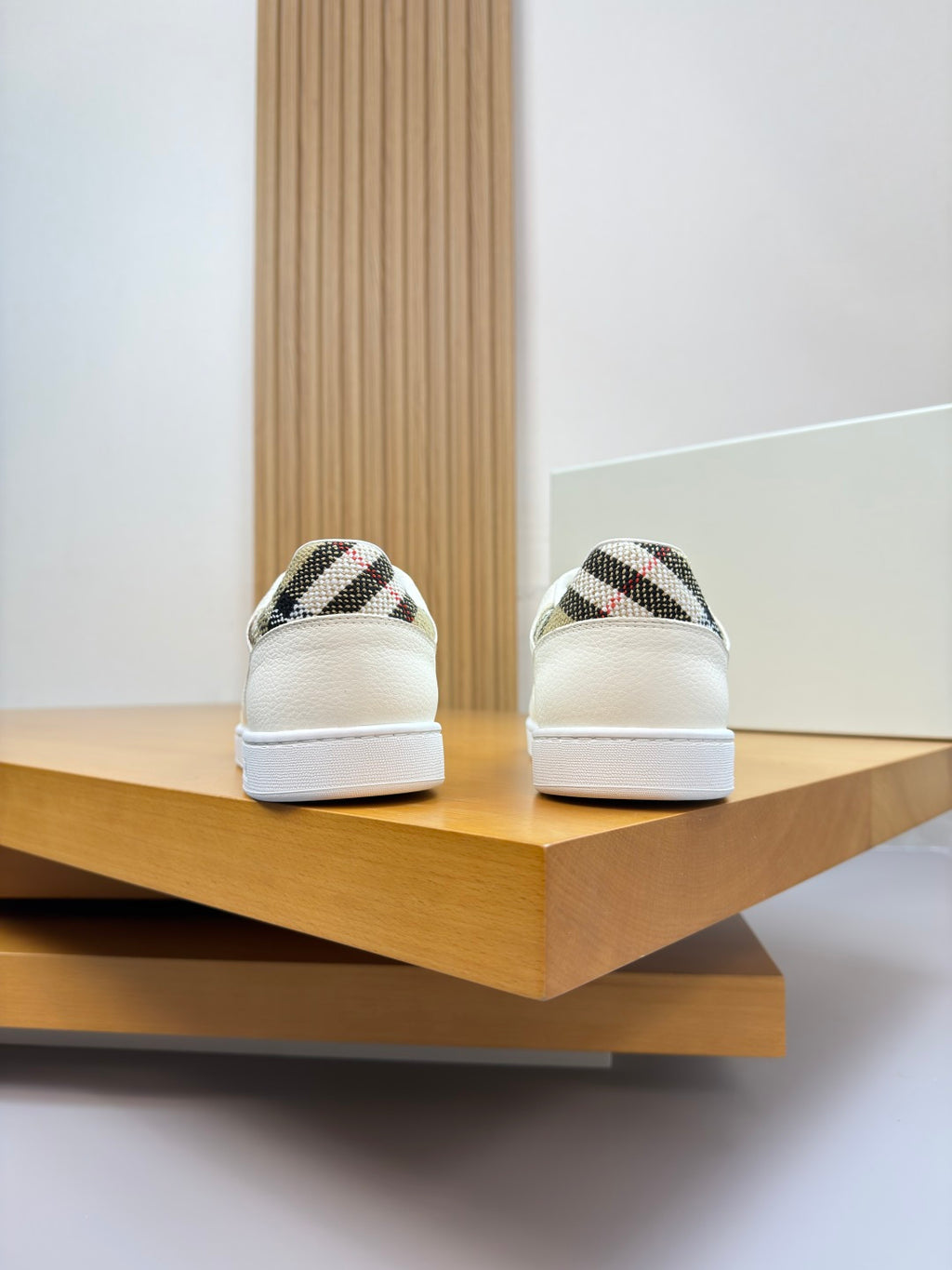 Back view of white leather sneakers with patterned heel panels
