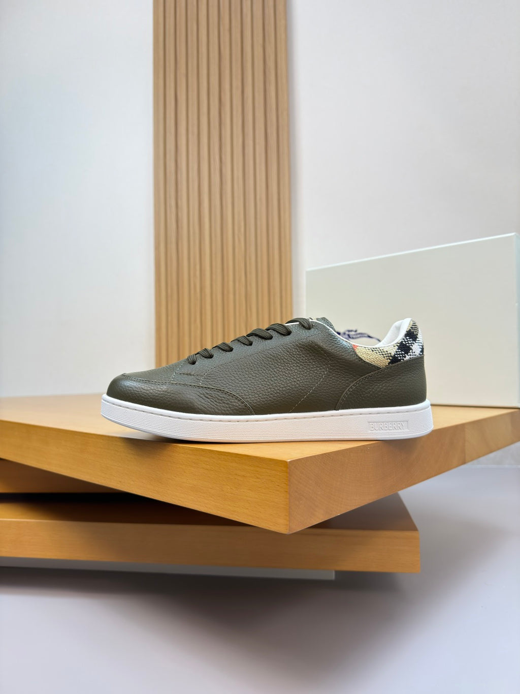 Olive green leather lace-up sneaker with white sole and patterned inner collar trim