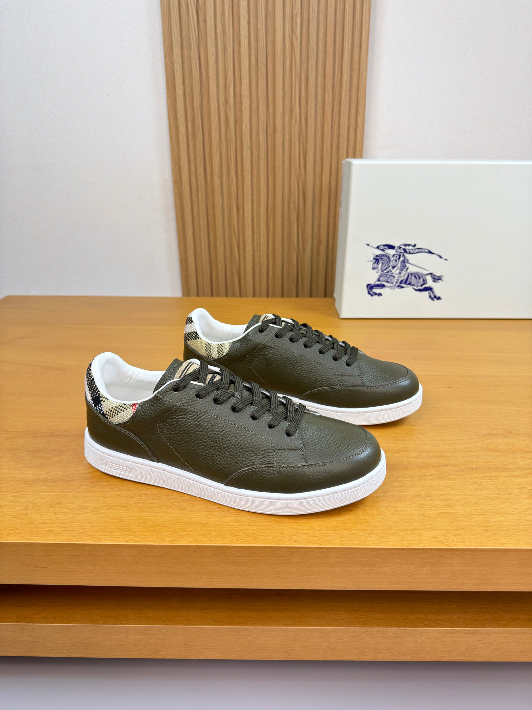 Olive green leather sneakers, lace-up design with black laces and white rubber sole