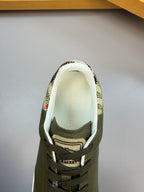 Olive green sneaker opening with Burberry logo on inner lining and patterned collar detail