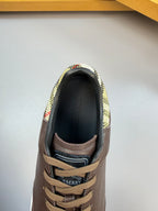 Brown sneaker interior with plaid lining at the collar and lace-up opening