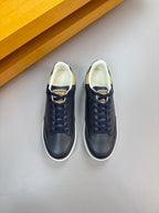 Navy lace-up sneakers with cream lining and check-pattern heel detail