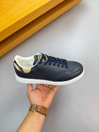 Navy sneaker held up, lace-up front with check-pattern collar and white sole