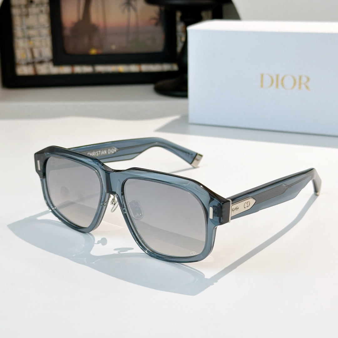 Light blue oversized sunglasses with clear-to-gray lenses and logo temple