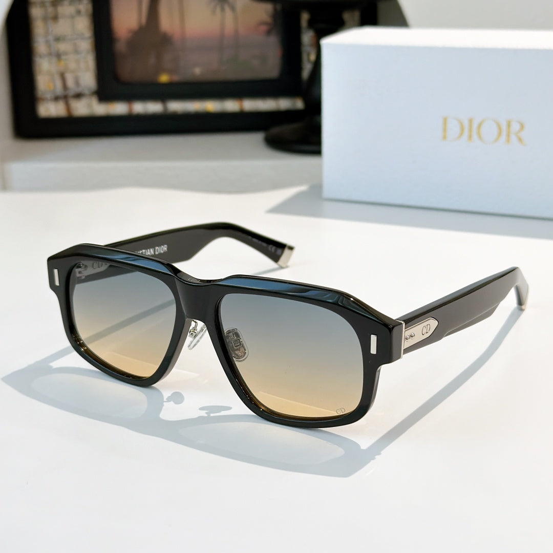 Black cat-eye sunglasses with amber-tinted lenses and gold-tone temple accents