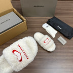 Balenciaga fuzzy white slide sandal with red logo on front strap