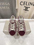 Maroon suede sneakers with white laces and beige rubber sole, front view pair.
