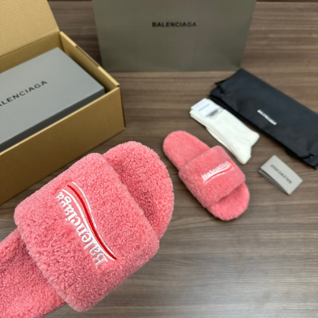 Pink terry slide sandal with large logo lettering on the padded front strap.