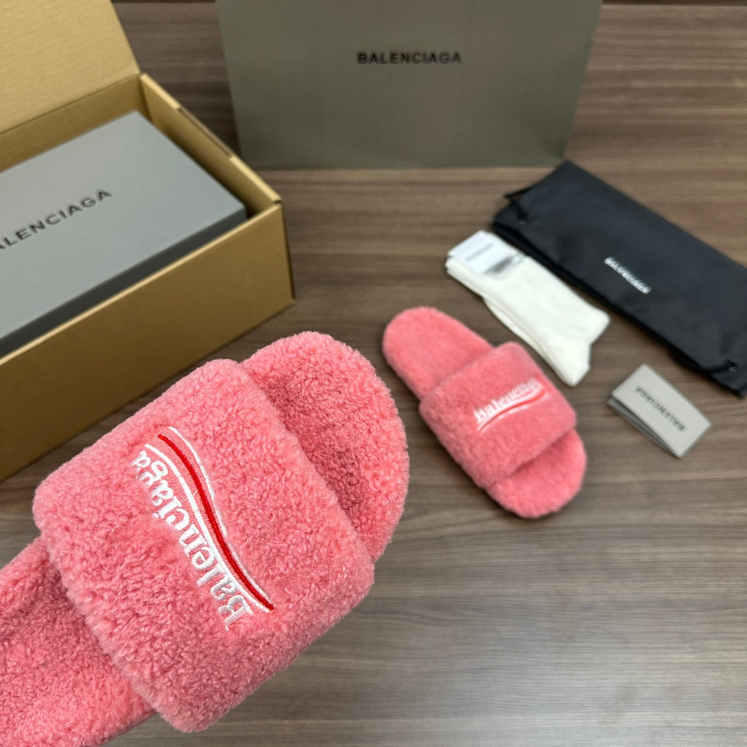 Pink terry slide sandal with large logo lettering on the padded front strap.