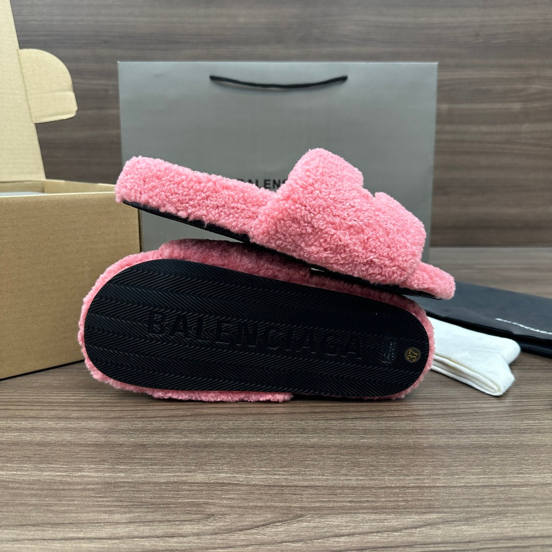 Pink terry slide sandal with black outsole, textured tread and Balenciaga embossing.