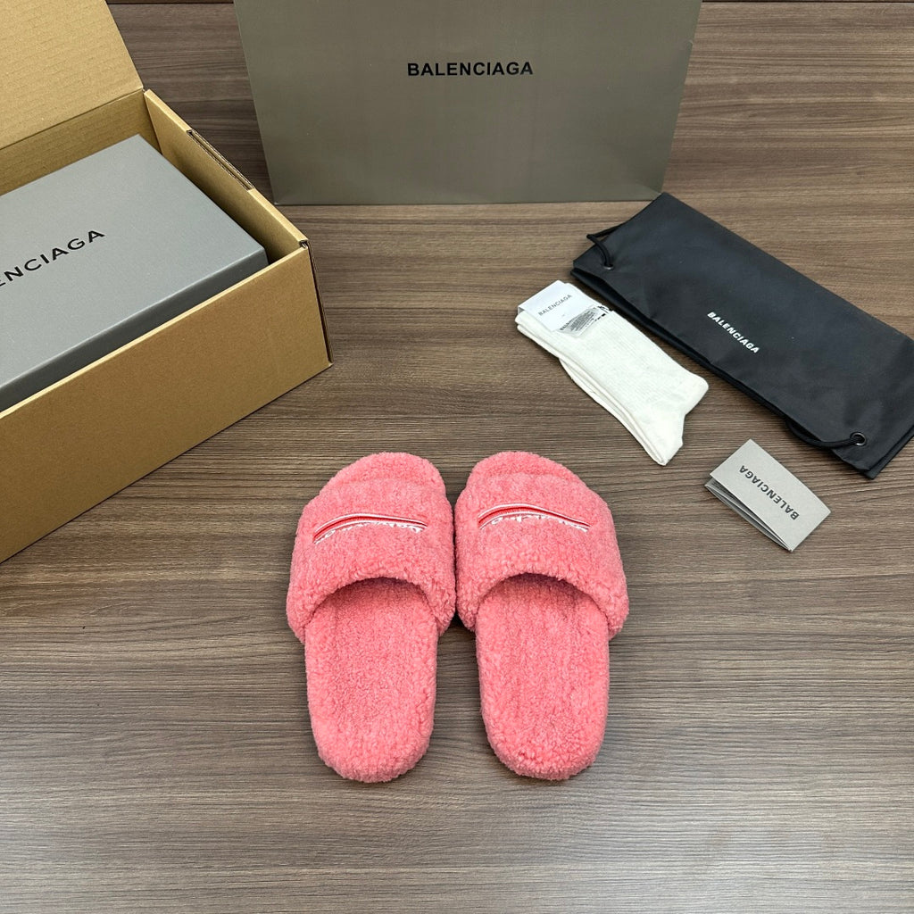 Pink terry slide sandals with embroidered logo stripe on the vamp, cushioned soles.