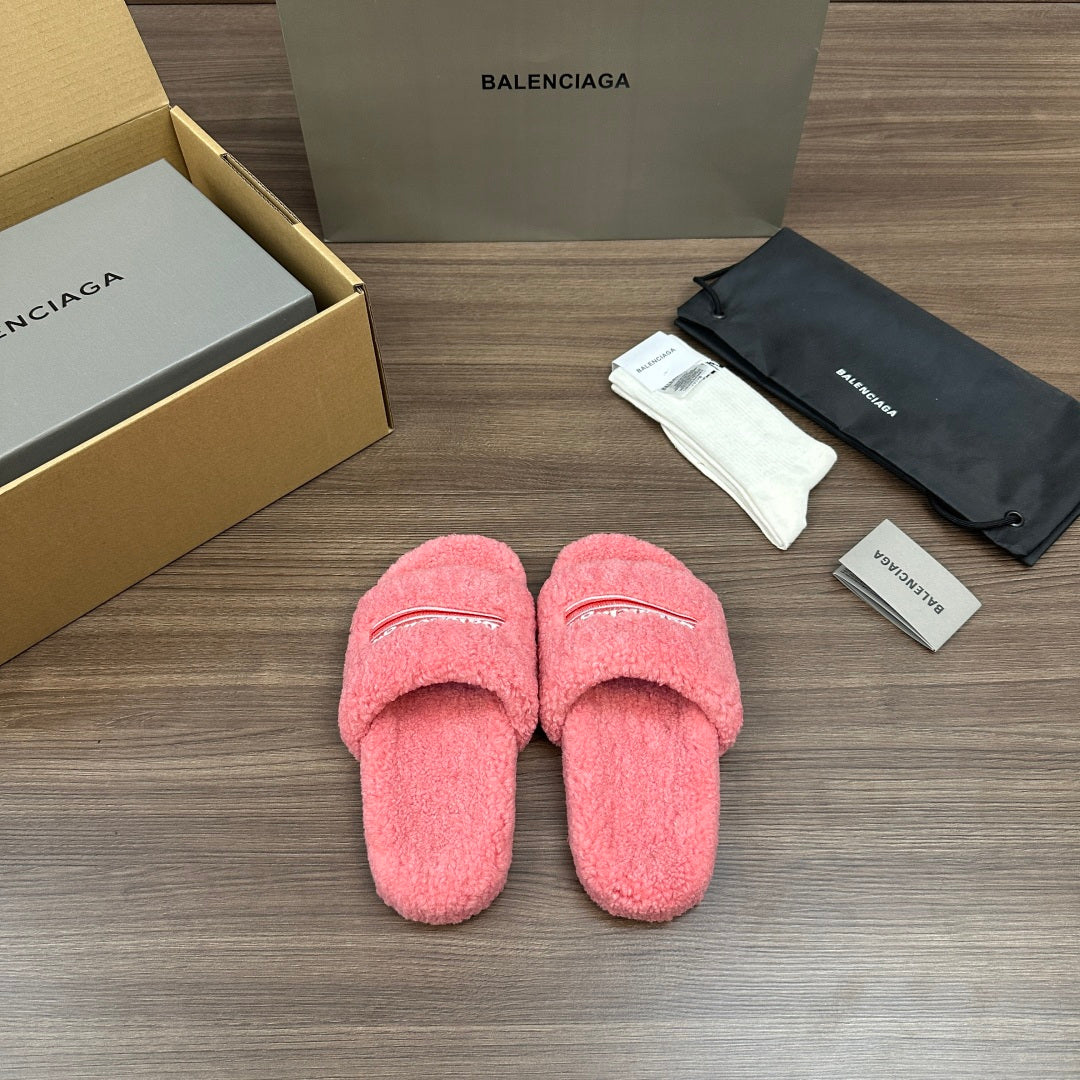 Pink terry slide sandals with embroidered logo stripe on the vamp, cushioned soles.