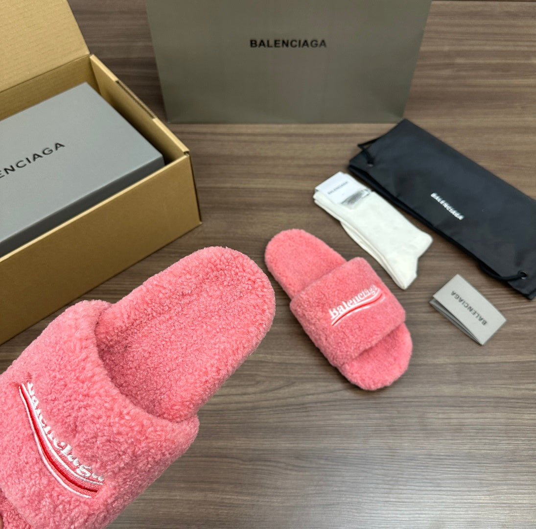Pink terry slide sandals showing logo strap details, padded footbeds and open toe.