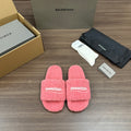 Pink terry slide sandals with Balenciaga logo strap, open toe, cushioned footbed.
