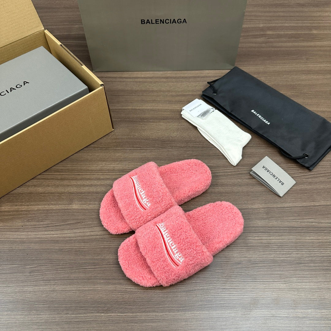 Pink terry slide sandals with logo embroidery on the padded crossing straps.