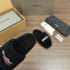 Black plush slide sandals with embroidered logo on strap, wide strap