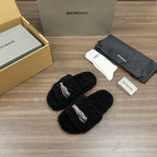 Black plush slide sandals with embroidered logo on strap, open toe
