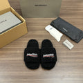 Black plush slide sandals with Balenciaga logo patch, open toe