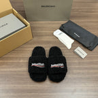 Black plush slide sandals with Balenciaga logo patch, open toe