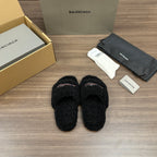 Black plush slide sandals, front view with red-white striped logo detail