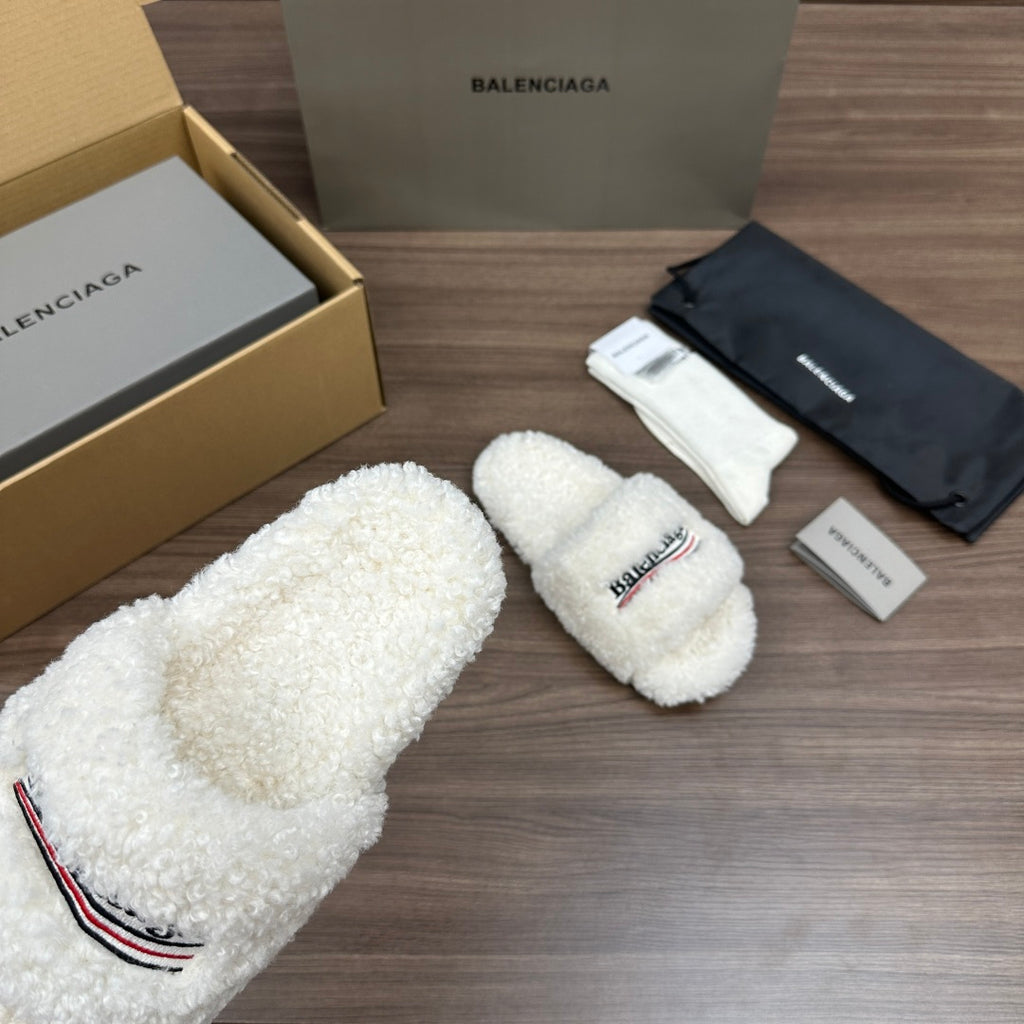 Balenciaga white teddy slide sandals with logo patch, angled view