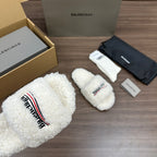 Balenciaga white teddy slide sandals, close view of logo patch