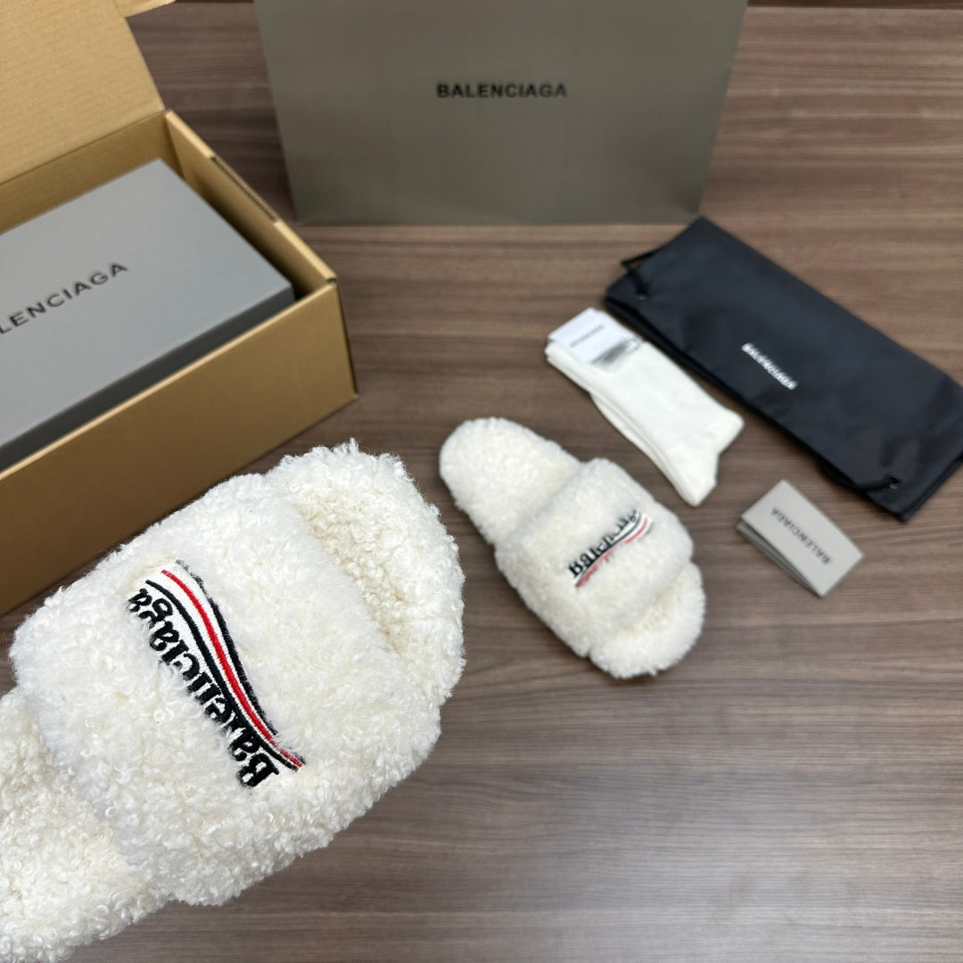 Balenciaga white teddy slide sandals, close view of logo patch
