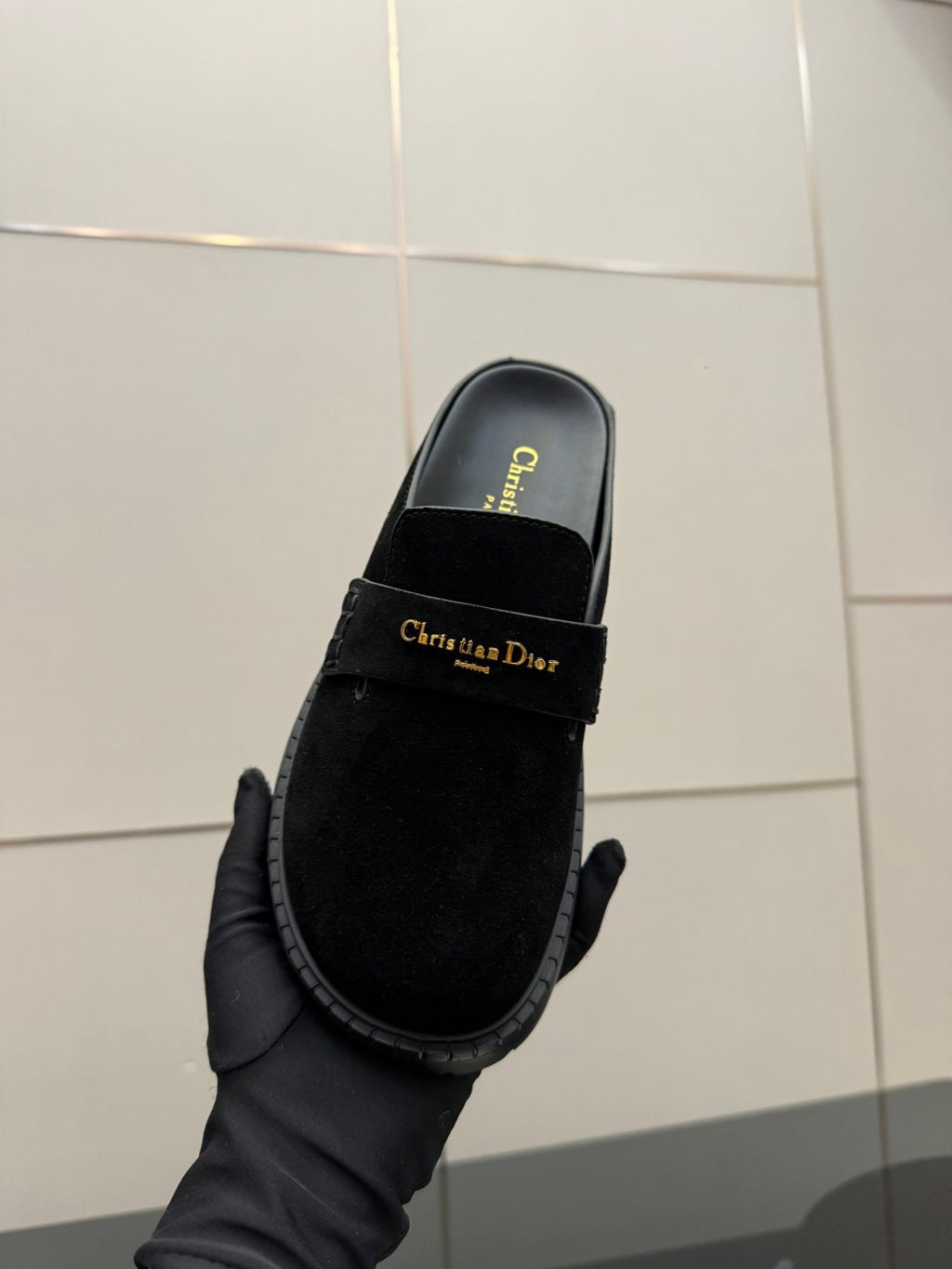 Black suede mule on hand, logo-printed footbed and gold buckle strap