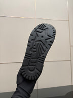 Black rubber outsole with star emblem and ridged tread pattern