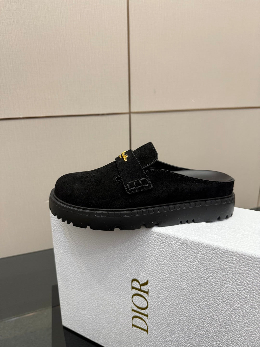 Black suede slide loafer with small strap and gold buckle detail