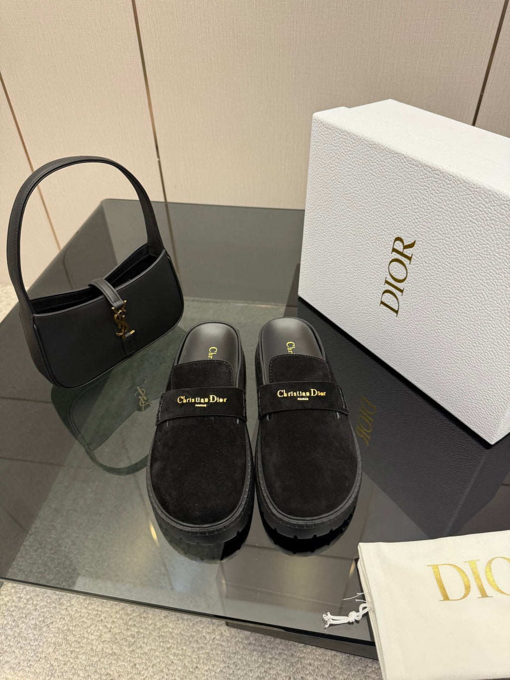 Pair of black suede loafers with gold buckle detail and chunky ridged sole