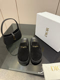 Pair of black suede loafers with gold buckle detail and chunky ridged sole
