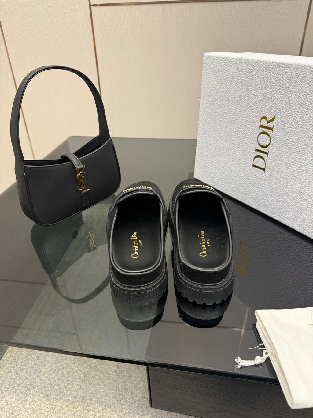 Black suede loafers, slip-on style with gold buckle detail and thick sole