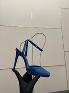 Women's blue patent heeled sandal with thin ankle straps, open toe on black stand