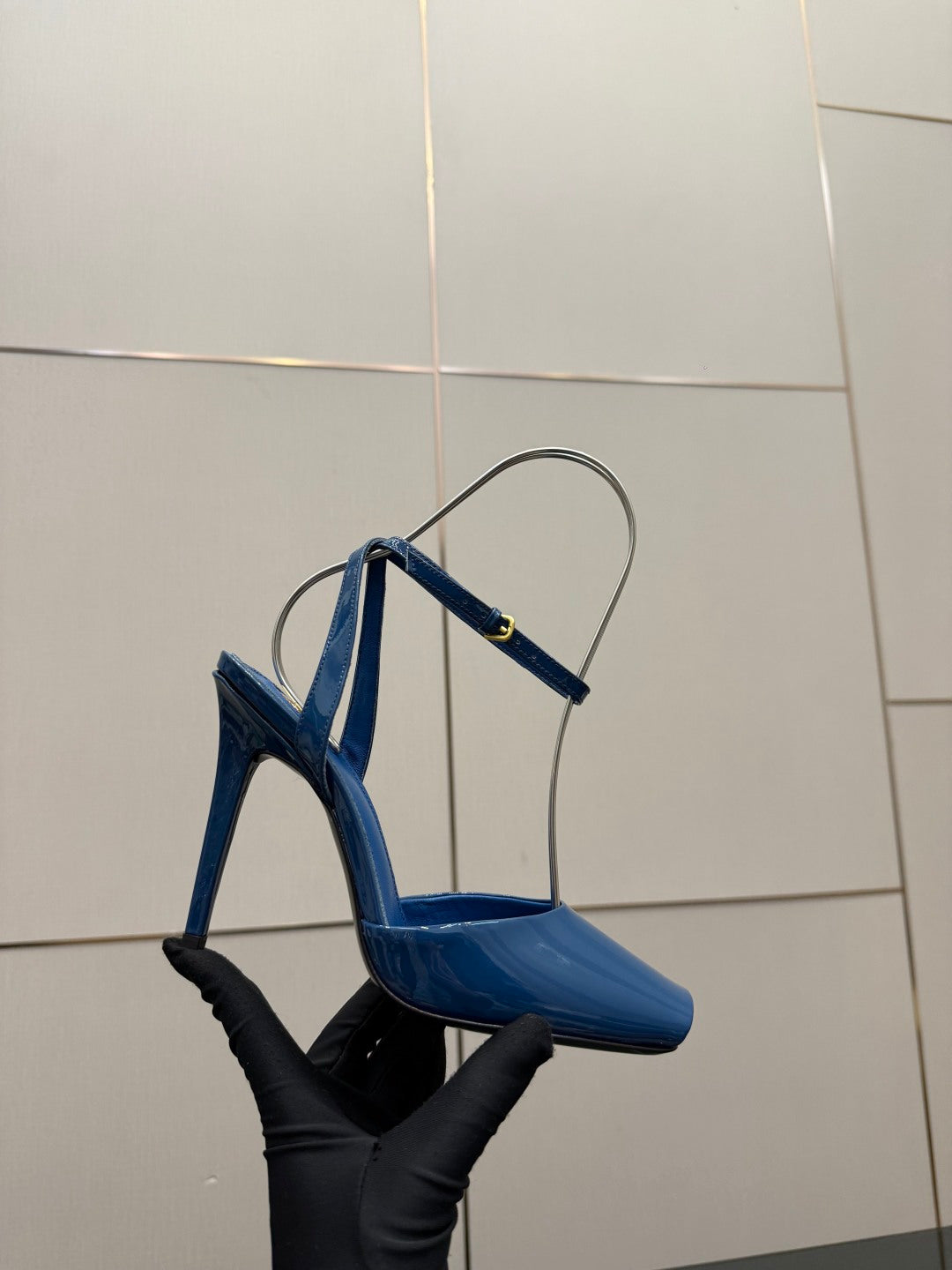 Women's blue patent heeled sandal with thin ankle straps, open toe on black stand