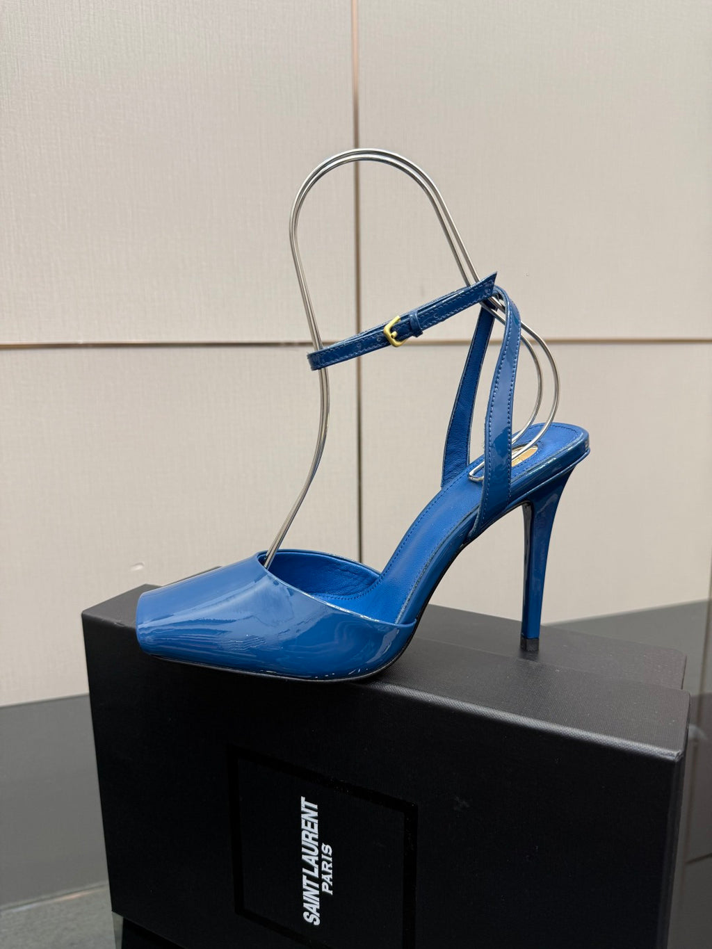 Women's blue patent heeled sandal with thin ankle strap and open toe on box