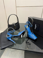 Women's blue patent heeled sandals with open toe and ankle straps, angled front view