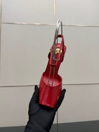 Red patent heeled sandals with ankle strap, shown from the side