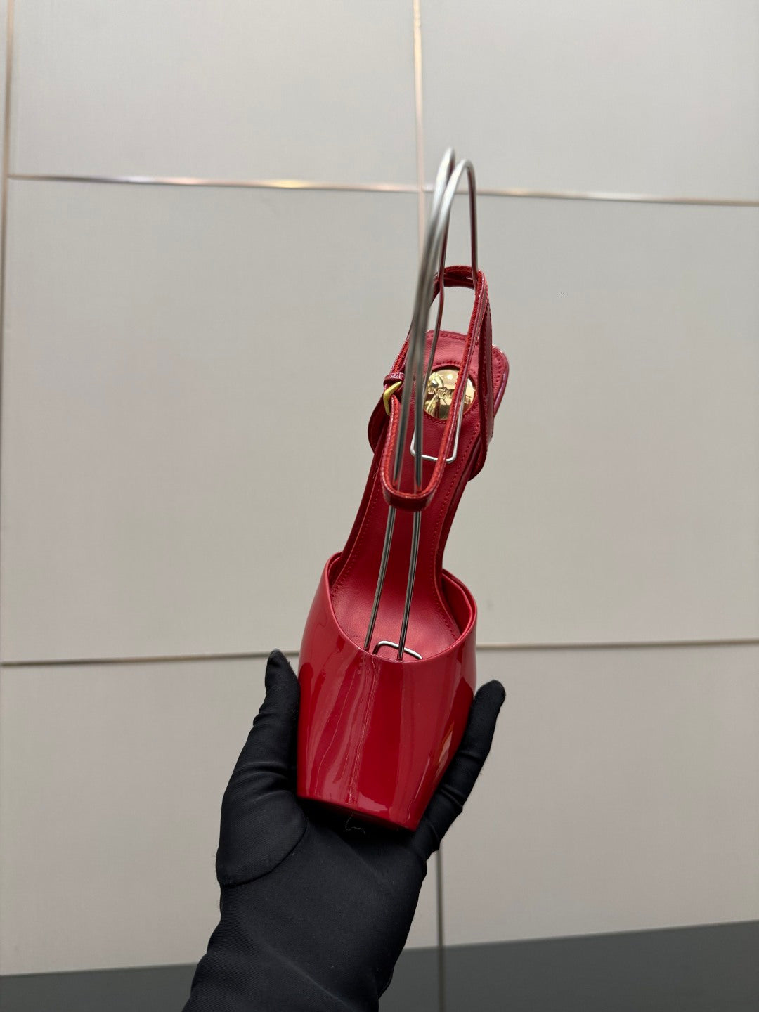 Red patent heeled sandals with ankle strap, shown from the side