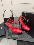 Pair of red patent stiletto heels with ankle straps and open sides