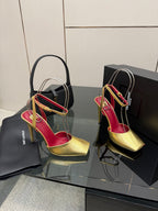 Pair of women’s gold high-heel sandals with red footbed and thin ankle straps
